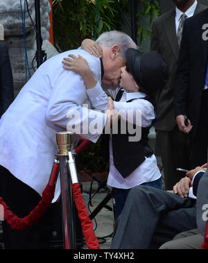 Writer/director/actor Mel Brooks is hugged by his grandson Henry Michael Brooks following Brooks' hands & footprints ceremony in the forecourt of the TCL Chinese Theatre (formerly Grauman's), in the Hollywood section of Los Angeles on September 8, 2014.The award-winning filmmaker wore a prosthetic sixth finger on one hand to add a little extra charm while pressing his feet and hands into cement. The 88-year-old comedian is celebrating the 40th anniversary of his Oscar-nominated film, 'Young Frankenstein.'  UPI/Jim Ruymen Stock Photo