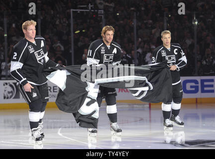 https://l450v.alamy.com/450v/ty4yey/los-angeles-kings-matt-greene-left-anze-kopitar-middle-and-dustin-brown-right-carry-the-stanley-cup-banner-in-a-ceremony-before-the-game-against-the-san-jose-sharks-at-staples-center-in-los-angeles-california-on-october-8-2014-upilori-shepler-ty4yey.jpg