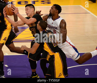 Los Angeles Lakers guard Jeremy Lin catches ball against Los Angeles Clippers center De'Andre Jordan as Lin teammate Wesley Johnson trails during second quarter action at Staples Center in Los Angeles, California on Friday October 31, 2014. The Clippers defeated the Lakers 118-111.  UPI/Jon SooHoo Stock Photo