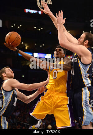 Los Angeles Lakers guard Nick Young shoots between Memphis Grizzlies' Jon Leuer (L) and Kosta Koufos (R) during the first half of their NBA game at Staples Center in Los Angeles, November 26, 2014.   UPI/Jon SooHoo Stock Photo