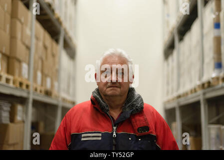 Wiesentheid, Germany. 25th June, 2019. Werner Beck, medical specialist for fresh plasma storage, looks at the photographer in a warehouse of the Blutplasma Bank of the Bavarian Red Cross. The temperature in the hall is -42° C. (to dpa 'Heat in Germany - cold places in Bavaria') Credit: Nicolas Armer/dpa/Alamy Live News Stock Photo