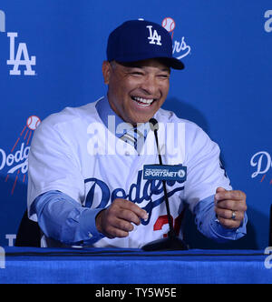 Dave Roberts, a former Dodger dons his new jersey as he is introduced as  the 10th manager of the Los Angeles Dodgers and the 28th in franchise  history, saying the post was