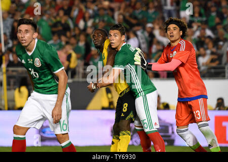 Jamaica forward Clayton Donaldson (8) is defended by Mexico defender Héctor Moreno (15) in front of the net on a corner kick during the second half of a 2016 Copa America Centenario Group A match at the Rose Bowl in Pasadena, California, on June 9, 2016. At left is Mexico midfielder Héctor Herrera and at right is Mexico goalkeeper Guillermo Ochoa. Mexico defeated Jamaica 2-0.     Photo by Michael Owen Baker/UPI Stock Photo