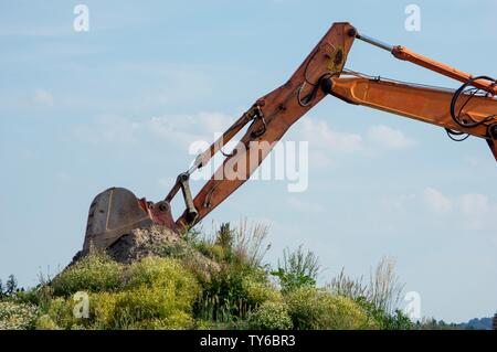 Excavator Arm against blue sky with clouds Stock Photo