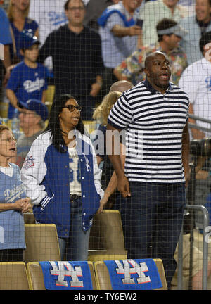 Basketball great Magic Johnson and his wife Cookie attend game 4 of the National League Championship Series at Dodger Stadium in Los Angeles, on October 19, 2016. Photo by Jim Ruymen/UPI Stock Photo