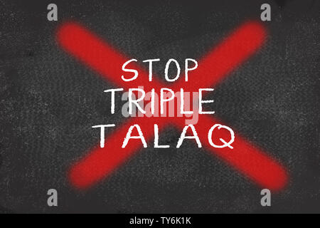 Concept of showing ban on Triple Talaq with red cross mark over triple talaq text black board Stock Photo