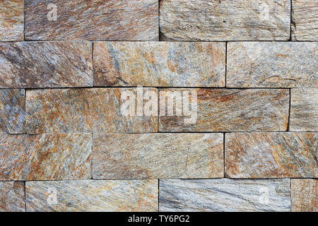 Texture of the brown and grey wall made of stone tile bricks Stock Photo