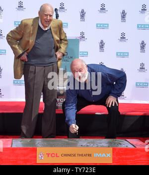 Actors and directors Carl Reiner (L) and Rob Reiner participate in a father and son double hand and footprint ceremony immortalizing them in the forecourt of TCL Chinese Theatre (formerly Grauman's) in the Hollywood section of Los Angeles on April 7, 2017. Photo by Jim Ruymen/UPI Stock Photo