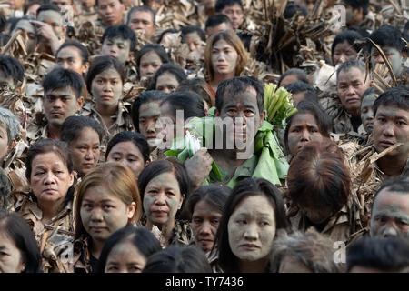 Devotees take part in the ‘Taong Putik’  or mud people festival in the town of Bibiclat,Aliaga,Nueva Ecija,Philippines.Held annually on the 24th June the century old religious festival honors the Christian Saint, John The Baptist. Before dawn those involved enter nearby rice fields adorning their bodies with mud & making cloaks made from torn banana leaves, twigs, and vines to emulate John the Baptist's appearance when he baptized Christ. Proceeding through the streets the procession is a form of penance On reaching their local Parish church a theatrical play is performed depicting the Life & Stock Photo