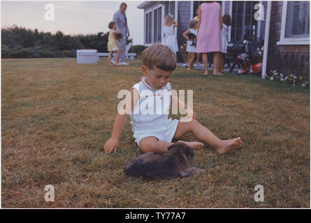John F. Kennedy Jr. with puppy. Hyannisport, MA, Squaw Island Stock Photo