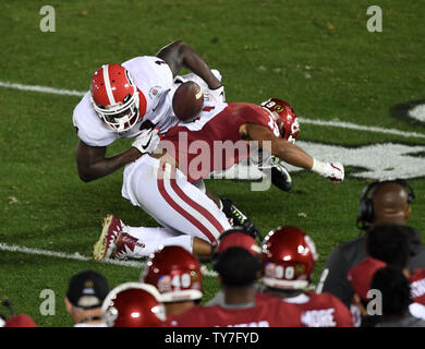 Georgia Bulldogs running back Sony Michel (1) fumbles after being hit by Oklahoma defender Caleb Kelly (19) in fourth quarter action at the Rose Bowl in Pasadena, California on January 1, 2018. Photo by Jon SooHoo/UPI Stock Photo