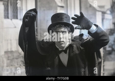 1980s, male street entertainer wearing a dress suit, a top hat and cloak, with black glove, England, UK. Stock Photo