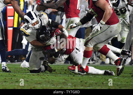 Los Angeles Rams defensive tackle Aaron Donald (L) tackles Atlanta Falcons running back Devonta Freeman (R) for a loss during their NFC Wild Card Playoff Game at the Los Angeles Coliseum in Los Angeles on January 6, 2018.     Photo by Jon SooHoo/UPI Stock Photo