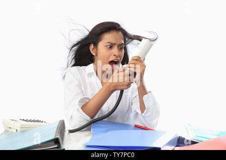 Businesswoman shouting on a telephone Stock Photo
