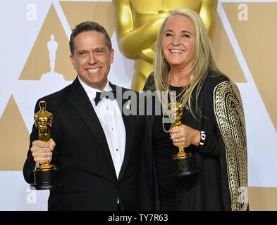 Filmmakers Lee Unkrich (L) and Darla K. Anderson, winners of the award for Best Animated Feature Film for 'Coco,' appear backstage with their Oscars during the 90th annual Academy Awards at Loews Hollywood Hotel in the Hollywood section of Los Angeles on March 4, 2018.  Photo by Jim Ruymen/UPI Stock Photo