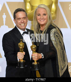 Filmmakers Lee Unkrich (L) and Darla K. Anderson, winners of the award for Best Animated Feature Film for 'Coco,' appear backstage with their Oscars during the 90th annual Academy Awards at Loews Hollywood Hotel in the Hollywood section of Los Angeles on March 4, 2018.  Photo by Jim Ruymen/UPI Stock Photo