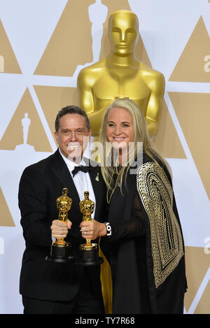 Filmmakers Lee Unkrich (L) and Darla K. Anderson, winners of the award for Best Animated Feature Film for 'Coco,' appear backstage with their Oscars during the 90th annual Academy Awards at Loews Hollywood Hotel in the Hollywood section of Los Angeles on March 4, 2018.  Photo by Jim Ruymen/UPI Stock Photo