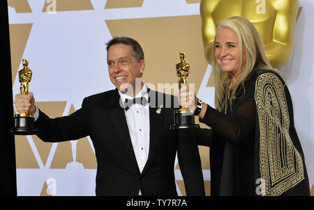 Filmmakers Lee Unkrich (L) and Darla K. Anderson, winners of the award for Best Animated Feature Film for 'Coco,' appear backstage with their Oscars during the 90th annual Academy Awards at Loews Hollywood Hotel in the Hollywood section of Los Angeles on March 4, 2018.  Photo by Jim Ruymen/UPI Stock Photo