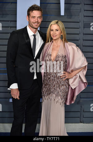 Mira Sorvino (R) and her husband Christopher Backus arrive for the Vanity Fair Oscar Party at the Wallis Annenberg Center for the Performing Arts in Beverly Hills, California on March 4, 2018. Photo by Christine Chew/UPI Stock Photo
