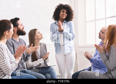 Grateful african woman sharing her progress with rehab group Stock Photo