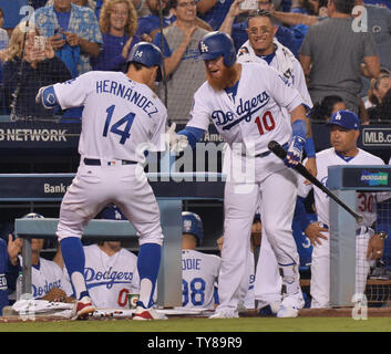 Los Angeles Dodgers' Cody Bellinger is welcomed home by teammates Chris  Taylor and Corey Seager after hitting a mammoth three-run shot to right  field n the third inning, his 39th homer of