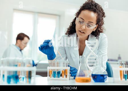 Professional female scientist taking a vaccine sample Stock Photo