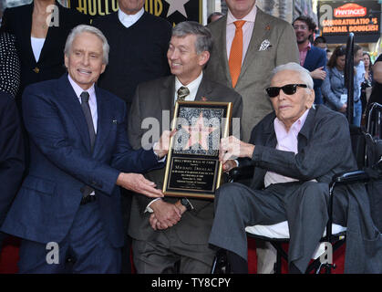 Actor Michael Douglas (L) holds a replica plaque with his father, actor Kirk Douglas during an unveiling ceremony honoring him with the 2,648th star on the Hollywood Walk of Fame in Los Angeles on November 6, 2018. Photo by Jim Ruymen/UPI Stock Photo