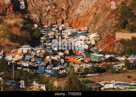 Pile of discarded cars stored on a rocky hillside in China Stock Photo
