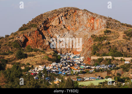 Pile of discarded cars stored on a rocky hillside in China Stock Photo