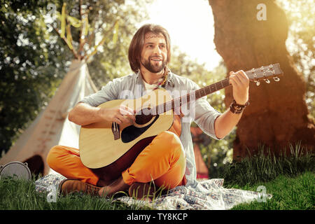 Joyful nice man creating a new melody Stock Photo