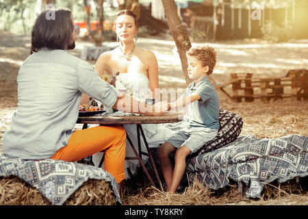 Nice spiritual family praying before their meal Stock Photo