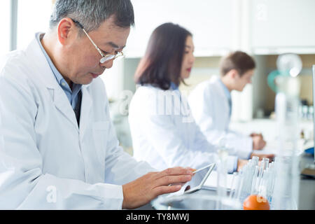 people doing chemical experiment in modern lab Stock Photo