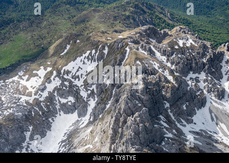 aerial, from a small plane, of Zuccone Campelli peak rock crags , shot from above in bright springtime light, near Barzio, Lecco, Orobie, Lombardy, It Stock Photo