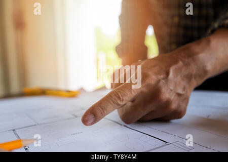 An architect or engineer pointing on blueprint, architectural concept Stock Photo