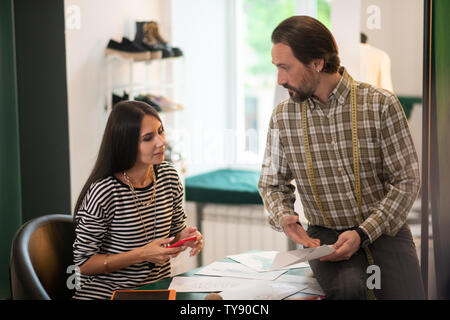 Charming good-looking talented appealing friendly fashion designers discussing work Stock Photo