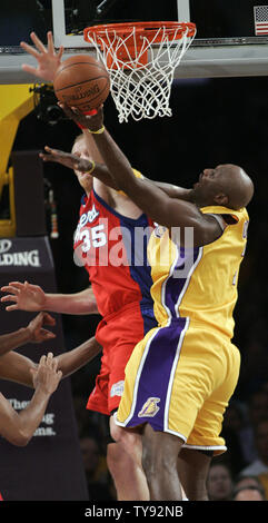 Los Angeles Clippers center Chris Kaman (35) trys to stop Los Angeles Lakers forward Lamar Odom in the second half of a NBA basketball game in Los Angles on October 27, 2009.  The Lakers won the game  99-92. UPI/Lori Shepler Stock Photo