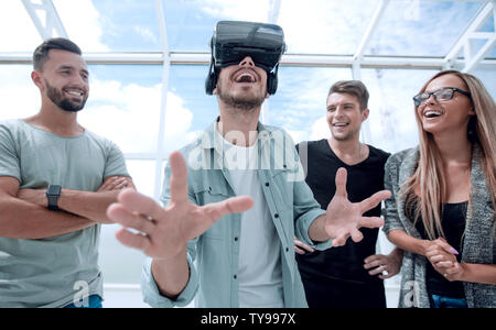 Testing new technologies. Attractive young woman in VR headset gesturing and smiling Stock Photo