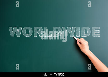 worldwide written on blackboard Stock Photo