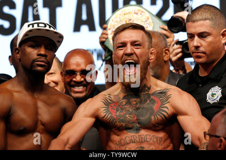 Floyd Mayweather and Conor McGregor appear on stage for the Weigh-In of the Floyd Mayweather vs. Conor McGregor 12-round super-welterweight boxing match, August 26, at T-Mobile Arena in Las Vegas, NV. Photo by James Atoa/UPI Stock Photo