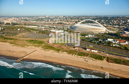 Drone aerial view of Moses Mabhida Stadium and beach shoreline in Durban. Kwazulu Natal, South Africa. Full colour horizontal image. Stock Photo