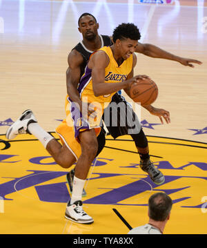 Los Angeles Lakers guard Nick Young (r) dribbles by Orlando Magic guard Ben Gordon during the first half of their NBA game at Staples Center in Los Angeles, January 9, 2015. The Lakers beat the Magic 101-84.   UPI/Jon SooHoo Stock Photo