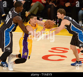 Los Angeles Lakers guard Jeremy Lin is trapped by Orlando Magic forward Andrew Nicholson(L) and Luke Ridenour during the first half of their NBA game at Staples Center in Los Angeles, January 9, 2015. The Lakers beat the Magic 101-84.   UPI/Jon SooHoo Stock Photo