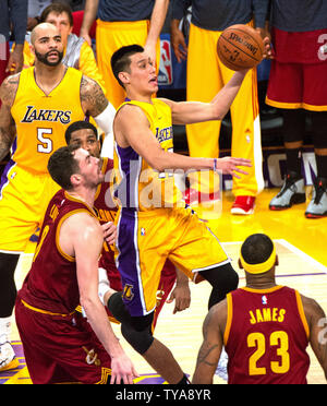 Los Angeles Lakers guard Jeremy Lin scores against  Cleveland Cavalier Kevin Love (L) and LeBron James during the second half of their NBA game at Staples Center in Los Angeles, January 15, 2015. The Cavaliers defeated the Lakers 109-102.  UPI/Jon SooHoo Stock Photo