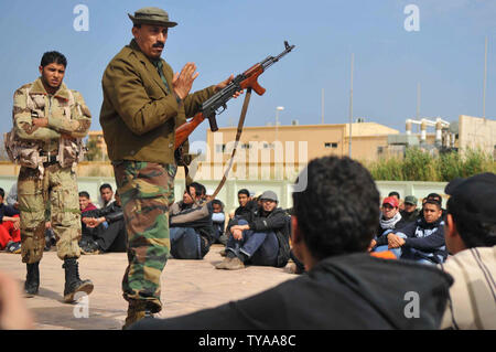 Rebel recruits listen during their first day of military training at a rebel militia center on March 3, 2011 in Benghazi, Libya. Supporters of the Libyan opposition, which controls Benghazi and most of eastern Libya, have been eager to join militia groups, which have been fighting the forces of President Muammar Gaddafi to the west near the capitol Tripoli.   UPI/Mohamaad Hosam Stock Photo