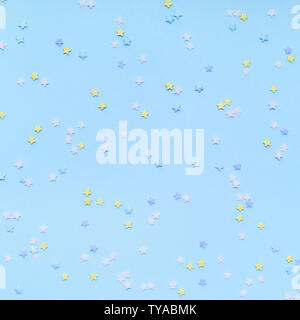 Little star-shaped confetti on a blue background. Holiday concept Stock Photo