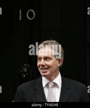 Prime Minister Tony Blair poses with his youngest son Leo, wife Cherie