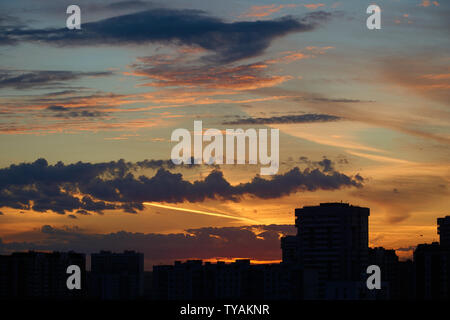Beautiful sunset scene in the city with dark silhouettes of buildings Stock Photo