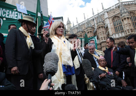 Actress and Gurkha campaigner Joanna Lumley (C) listens to Home secretary Jacqui Smith announce victory for the campaign for Gurkha soldiers to be allowed to stay in the United Kingdom after four years of service in London on May 21, 2009. Many Gurkha soldiers had been living in severe poverty since leaving the British army, but are now entitled to the same rights as British servicemen. (UPI Photo/Hugo Philpott) Stock Photo