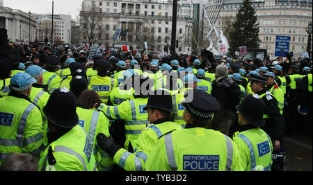 Police officers hold back students in Trafalgar Square during a protest over tuiton fees and university funding increases in London on November 30 2010.This is the third protest in the last month with the pressure increasing on the coalition government.    UPI/Hugo Philpott Stock Photo