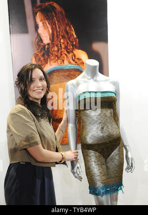 British designer Charlotte Todd attends a Passion For Fashion Auction photo call with the see through dress Kate Middleton wore on the catwalk at St. Andrew s University Charity Fahion Show in 2002